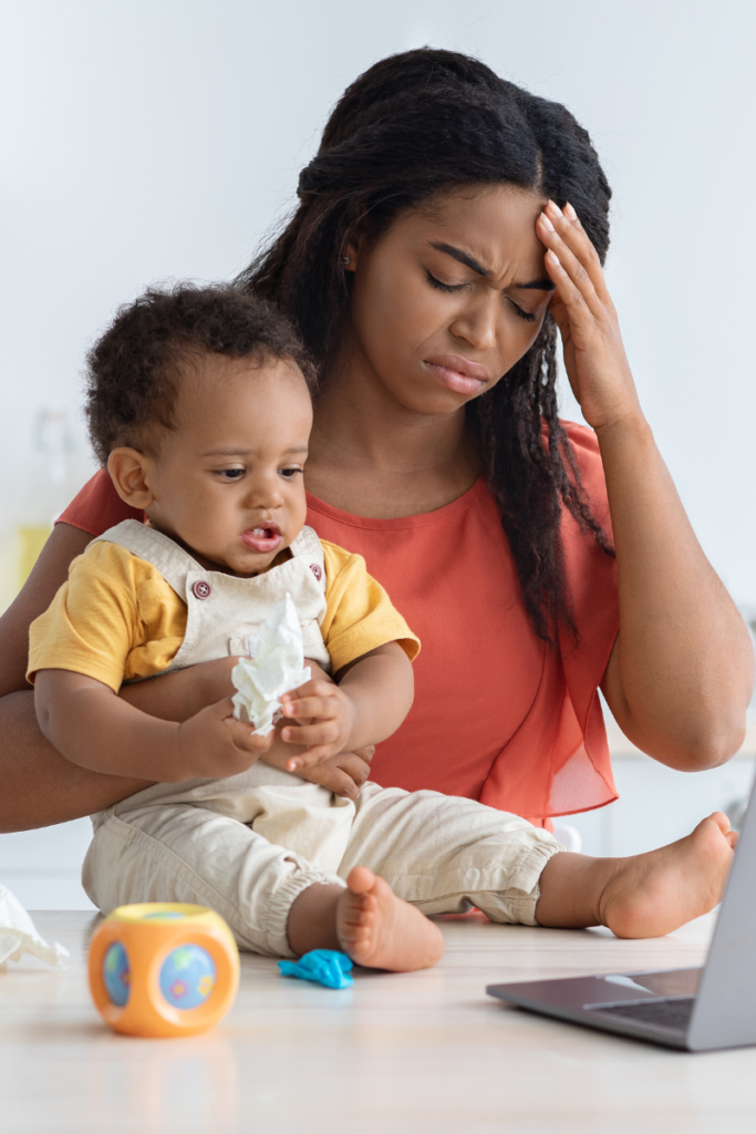 mom and baby at kitchen counter with a laptop in front of them - the truth about mom guilt