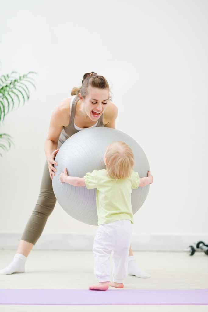 mom and baby playing with exercise ball