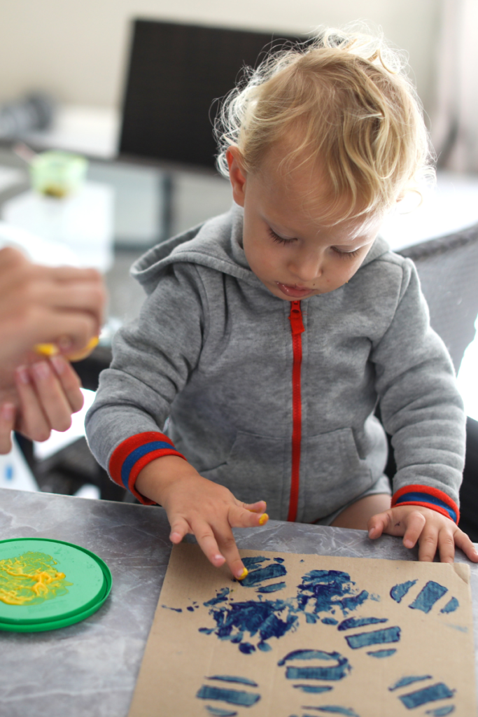 baby boy playing with finger paints