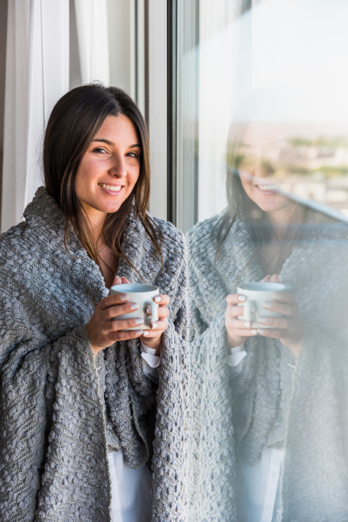 woman with a shawl holding coffee - parenting blindsides