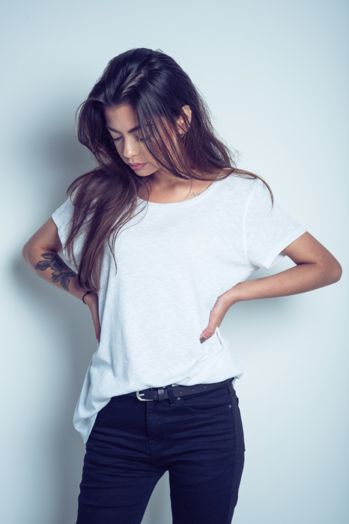 woman looking disappointed with a white shirt and black pants