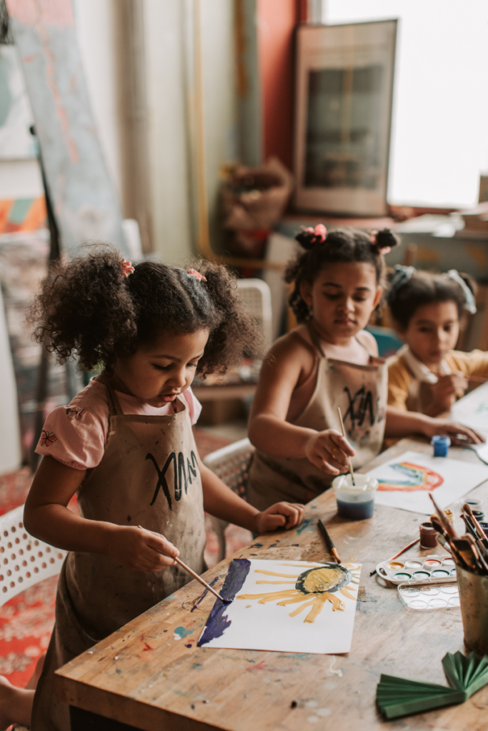 Girls painting with aprons - unexpected moments