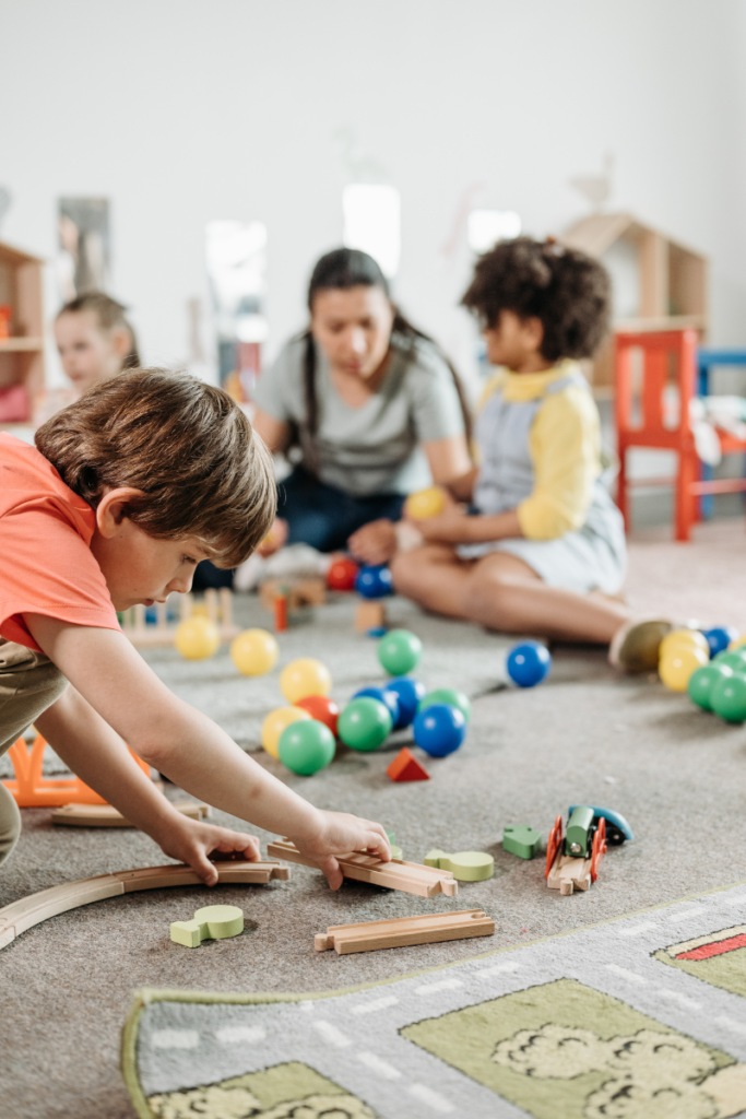 Kids playing with toys on the floor of a daycare