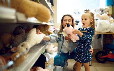 mom and daughter picking out a stuffed animal at the store - the power of saying yes